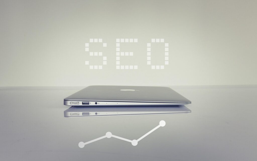 seo services has a laptop and a word seo on it
